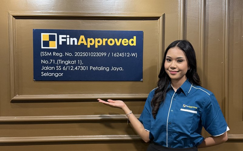 FinApproved team member beside the company office signage